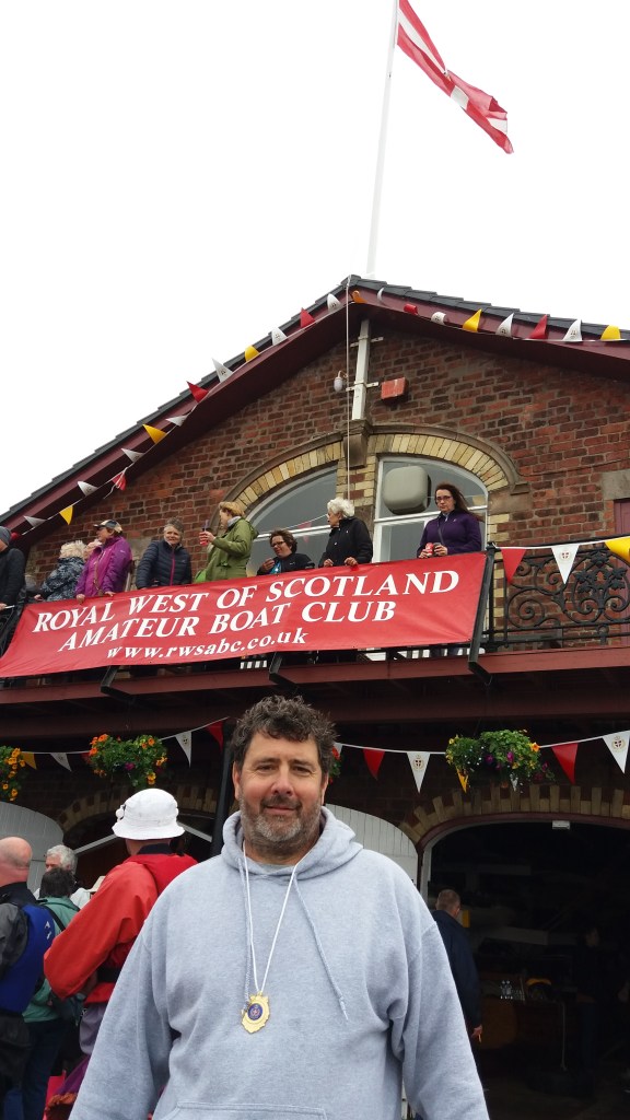 Another balmy summer day in Scotland, with my medal in front of the club
